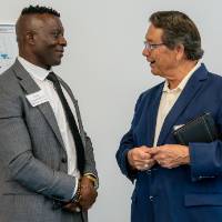 Felix Ngassa and Jim Brooks in conversation